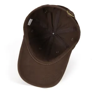 Detail view of cotton baseball cap interior with reinforced seams and brass buckle