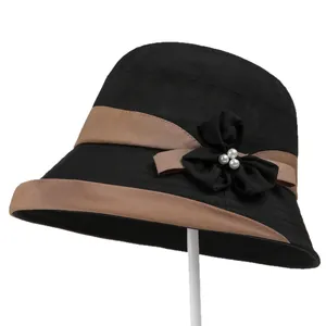 Elegant black sun hat for women with brown ribbon and pearl flower detail