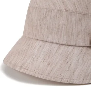Close-up of khaki linen sun hat showing breathable textured fabric and fine stitching detail