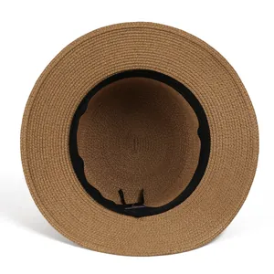Interior view of a French style straw boater hat showing sweatband and adjustable drawstring