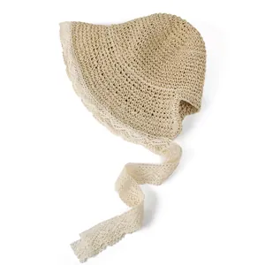 Women's hollow straw sun hat with delicate white lace trim and ribbons for summer beach