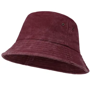 Detail of burgundy washed denim bucket hat showing metal eyelets and stitched brim