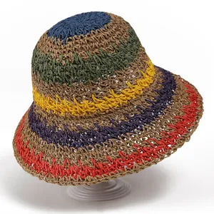 Close-up of rainbow woven straw sun hat showing colorful stripes and hollow texture