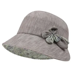 Detail of grey sun hat with floral lining and bow decoration for women