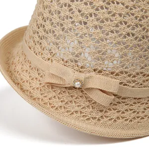 Elegant beige woven straw sun hat with ribbon bow, pearl, and rhinestone detail