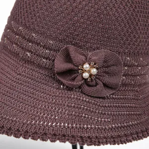 Women's sun hat with knit hollow design and elegant bow with pearl embellishment