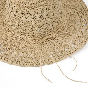 Macro shot of breathable hollow-out straw weaving and delicate bow on sun hat