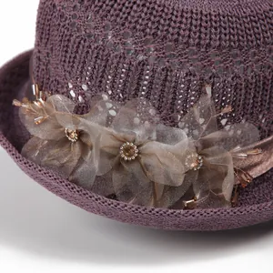 Elegant purple woven sun hat for women featuring a delicate mesh flower and crystal beads