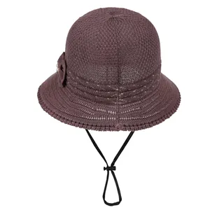 Deep purple knit bucket hat for women with bow and pearl detail on white background