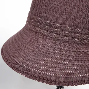 Detail of purple knitted sun hat showing intricate crochet texture and striped patterns