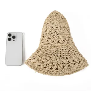 Hollow straw sun hat with wide brim and wave knit texture shown with smartphone for scale