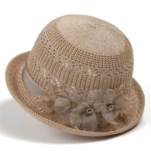 Detailed hollow weave texture of khaki sun hat with floral mesh and bead decoration