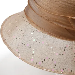 Detail of elegant organza sun hat with shimmering sequins and satin ribbon decoration