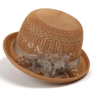 Detailed shot of the mesh weave sun hat with satin ribbon and crystal floral decoration