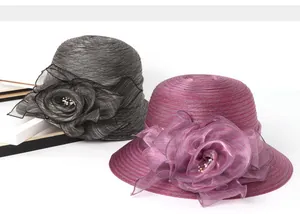 Detail of organza sun hats with layered fabric flowers and white pearl centers