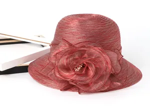 Close-up of deep red organza sun hat featuring a large handmade flower with white pearls