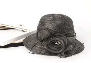 Close-up of dark grey organza sun hat featuring large decorative flower and pearl beads