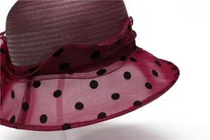 Detail of wine red sun hat with polka dot organza mesh brim and wavy ruffled edge