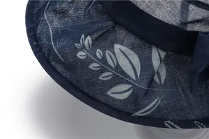 Detail of dark blue sun hat with floral pattern and decorative bow for women