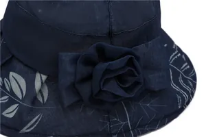 Detailed close-up of dark blue sun hat featuring a mesh flower and grey leaf pattern