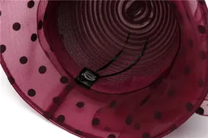 Detail of the inner black adjustable strap and brand label on a mesh sun hat