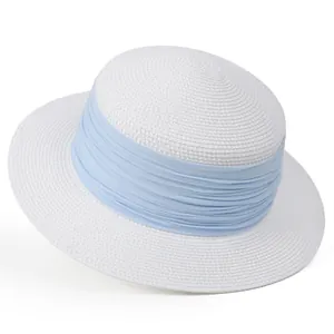 Détail d'un chapeau de paille blanc avec un ruban en tissu bleu clair pour l'été