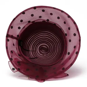 Detail of burgundy organza sun hat with black polka dots and wavy brim for women