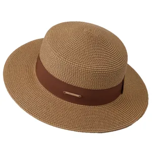 Elegant wide brim straw hat with brown ribbon and gold plaque for sun protection