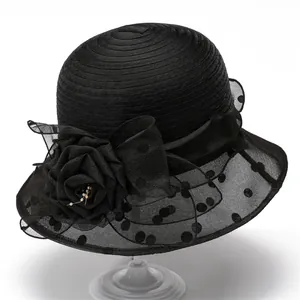 Elegant black sun hat with organza floral accent and polka dot mesh brim for women