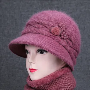 Women's warm knitted hat and scarf set with pearls and knit flowers in purple color