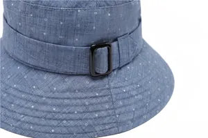 Detailed view of light blue polka dot bucket hat with decorative strap and black buckle