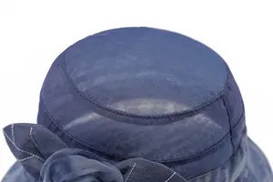Detailed close-up of dark blue mesh sun hat with intricate floral embroidery and texture
