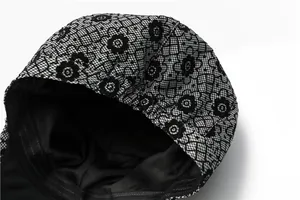 Détail du bonnet en dentelle noire avec doublure en soie lisse et bord élastique