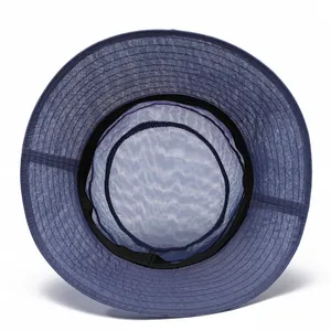 Detail of dark blue sun hat featuring a breathable mesh top and reinforced stitching
