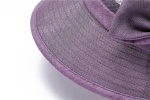 Close-up of purple sun hat with breathable mesh texture and decorative side bow detail