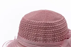 Detail of elegant pink organza sun hat with breathable texture and ribbon bow decoration