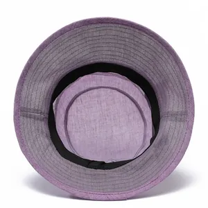 Detail of purple breathable woven fabric and black sweatband inside a summer sun hat