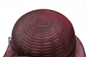 Detailed macro view showing spiral stitching and mesh veil on elegant burgundy sun hat