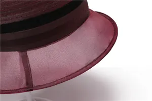Detail of burgundy organza sun hat featuring precise stitching and black decorative trim