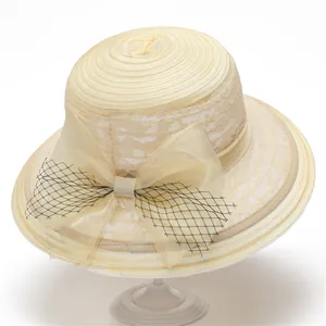 Détail d'un élégant chapeau de soleil beige en organza avec nœud en maille noire