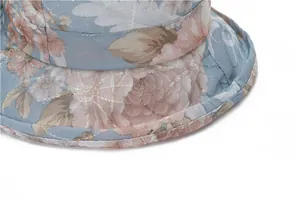 Detail of floral printed sun hat featuring quilted texture and precise stitching detail