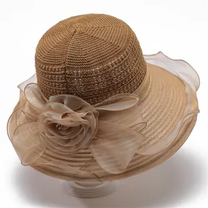 Detailed view of elegant organza flower on a wide brim straw sun hat for women
