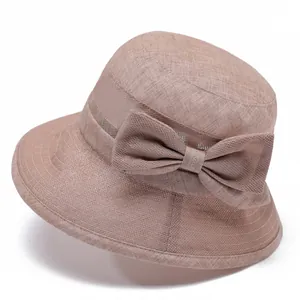 Detail of breathable mesh fabric and bow ornament on a pink sun hat for elderly women