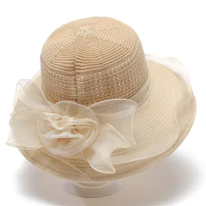 Detail of elegant organza flower with bead center on a woven summer sun hat