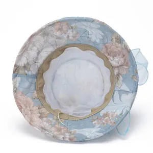 Detail view of breathable mesh lining and floral chiffon fabric on a blue sun hat