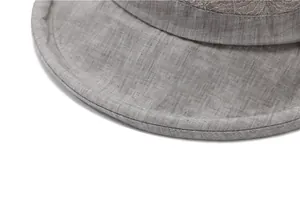 Detail of light gray cotton linen sun hat with elegant lace patchwork and neat stitching