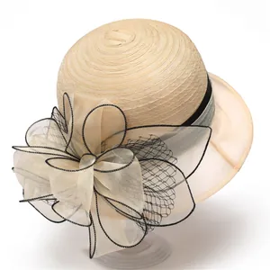 Detail of elegant organza bow and black trimmed mesh on a French style summer sun hat