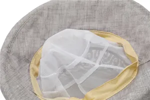 Detail of grey sun hat showing breathable mesh lining and yellow sweatband inside