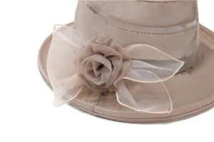 Close-up of khaki sun hat featuring breathable mesh and a large decorative mesh rose flower