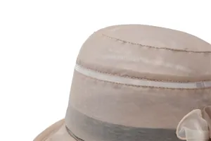 Detailed close-up of champagne sun hat with elegant mesh overlay and flower decor